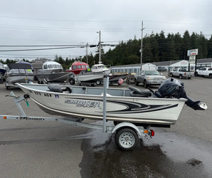 White Smoker Craft fishing boat with Yamaha 20HP outboard, on EZ Loader trailer, parked on wet pavement at Y Marina lot