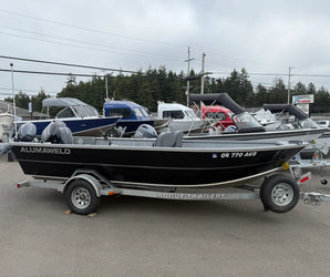 Black Alumaweld boat with Yamaha engines on a Rogue Trailer, parked at Y Marina among other boats on display