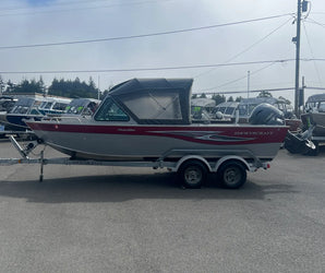 SmokerCraft Phantom boat with red and silver design on trailer, featuring Yamaha outboard, parked at Y Marina dealership lot