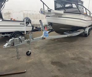 EZ Loader dual-axle boat trailer with heavy-duty frame and winch available at Y Marina