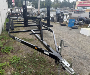 Black Trailmaster boat trailer with heavy-duty frame and winch available at Y Marina